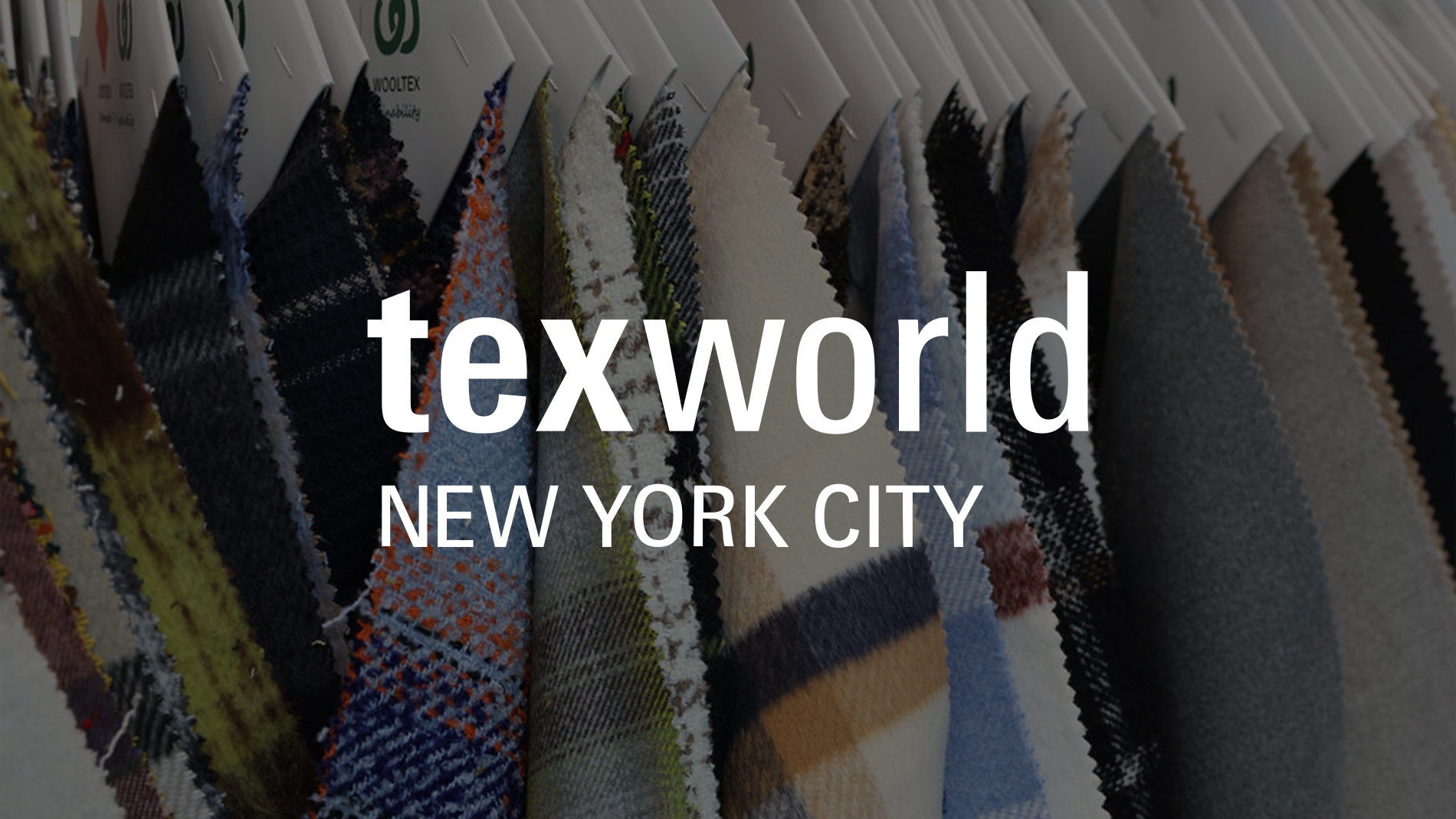 Attendees exploring diverse textile designs at a booth during Texworld New York.